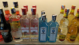 Bottles of exotic drinks from Brazil, Thailand, and Germany lined up on a shelf.
