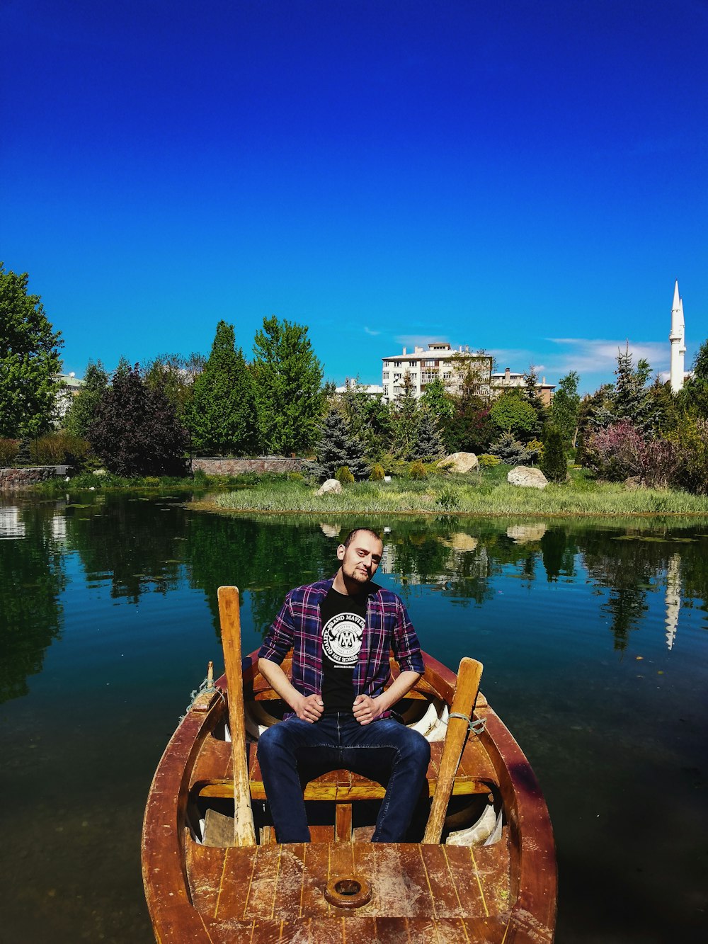 man in a brown wooden boat