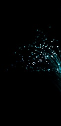 A dark background with glowing turquoise fiber optic strands fanning outwards, creating a captivating visual of shimmering lights and sparkling points.