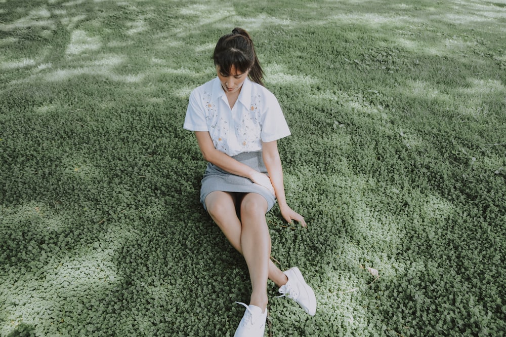 woman sitting on grass