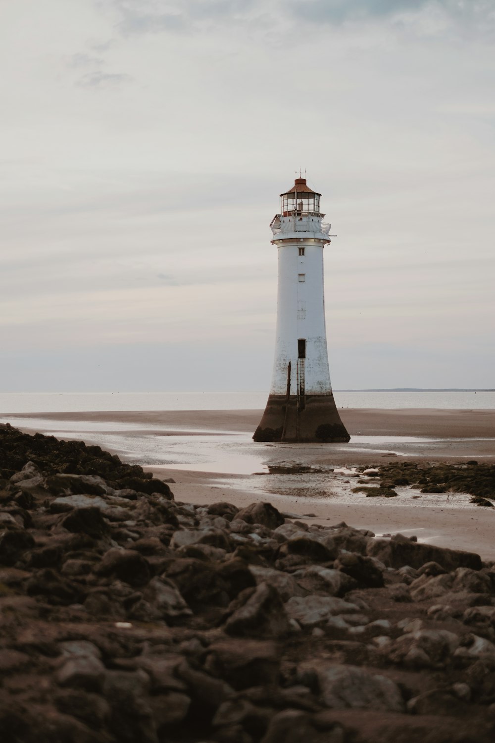 white lighthouse on seashore
