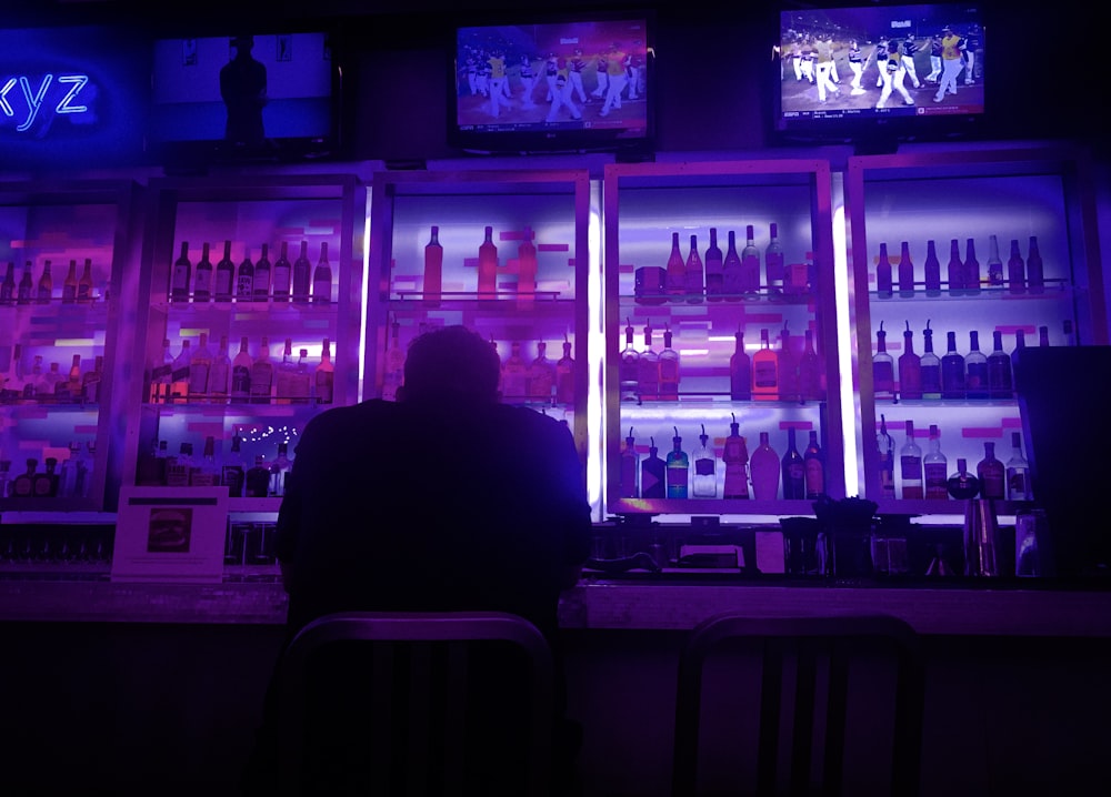 person sitting beside bar counter