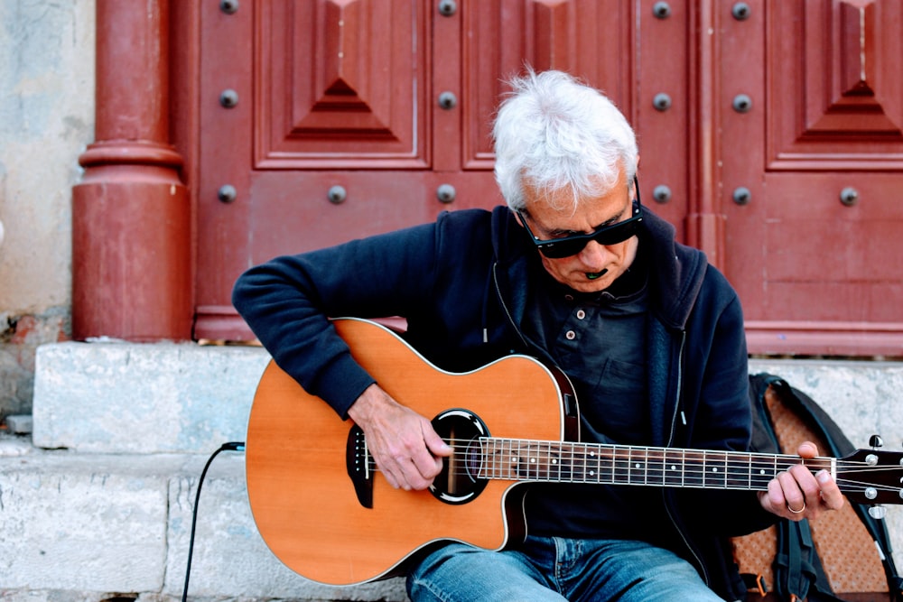 man playing acoustic guitar