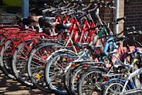lined red, blue, and black bicycles on display