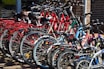 lined red, blue, and black bicycles on display