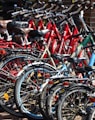 lined red, blue, and black bicycles on display