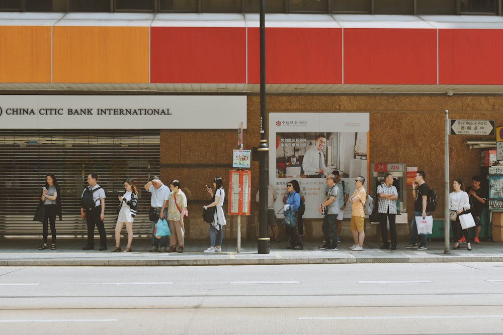 people fall inline on sidewalk