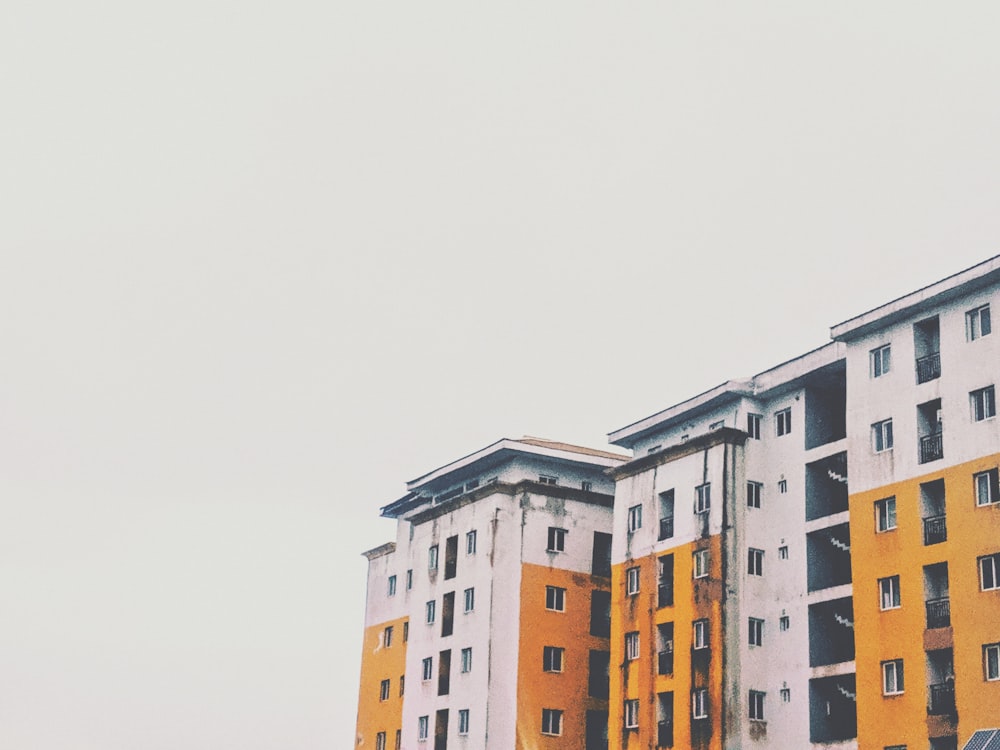 yellow and white concrete high-rise building