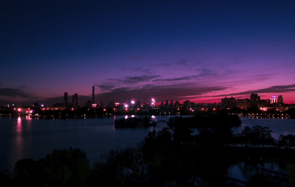 silhouette of city buildings during nighttime