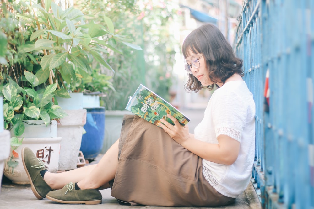 woman siting while reading book