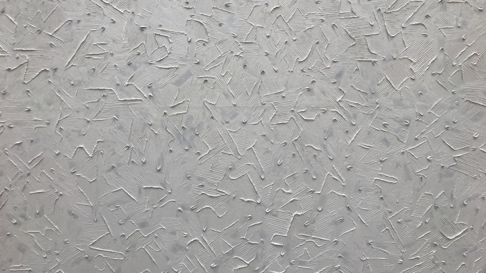 a close up of a textured surface with white paint