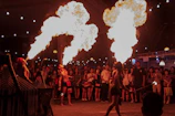 Staff performing a captivating fire show at an outdoor evening event.