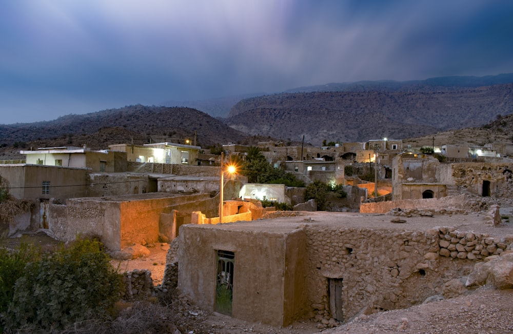 brown concrete houses and mountain scenery