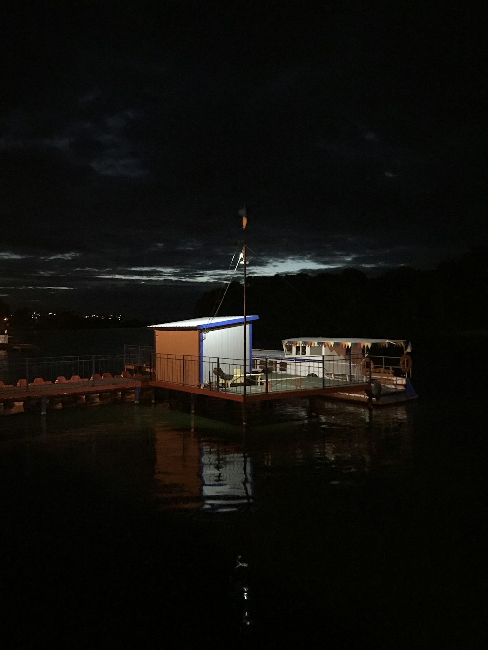 white and blue house near body of water during nighttime