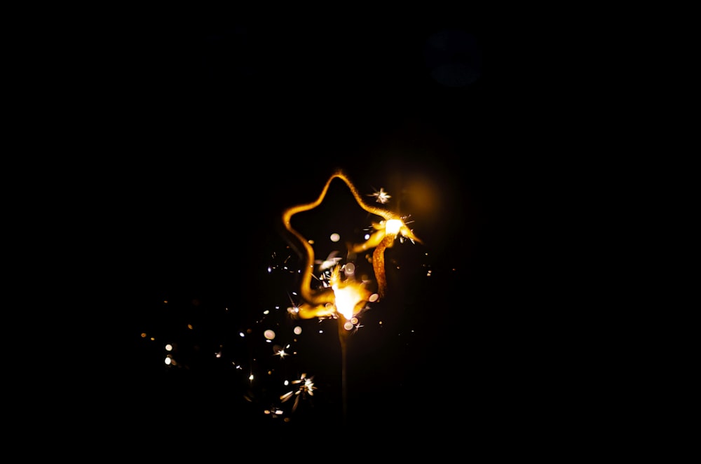 a sparkler is lit up in the dark