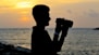 silhouette of man holding camera