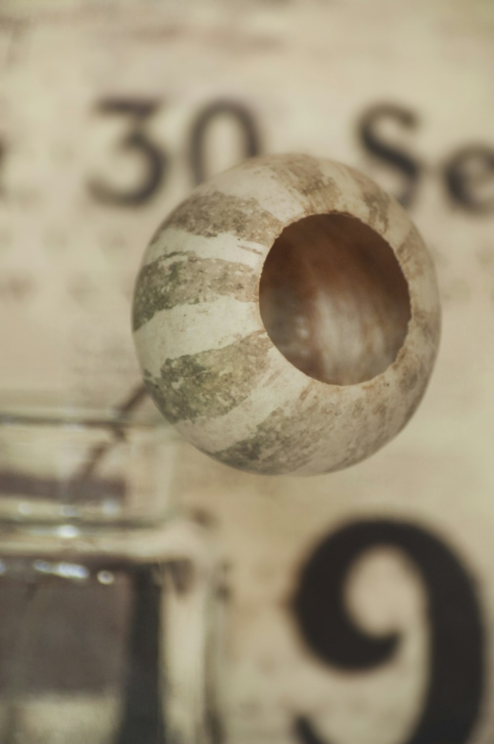 a close up of a glass jar with a wooden spoon