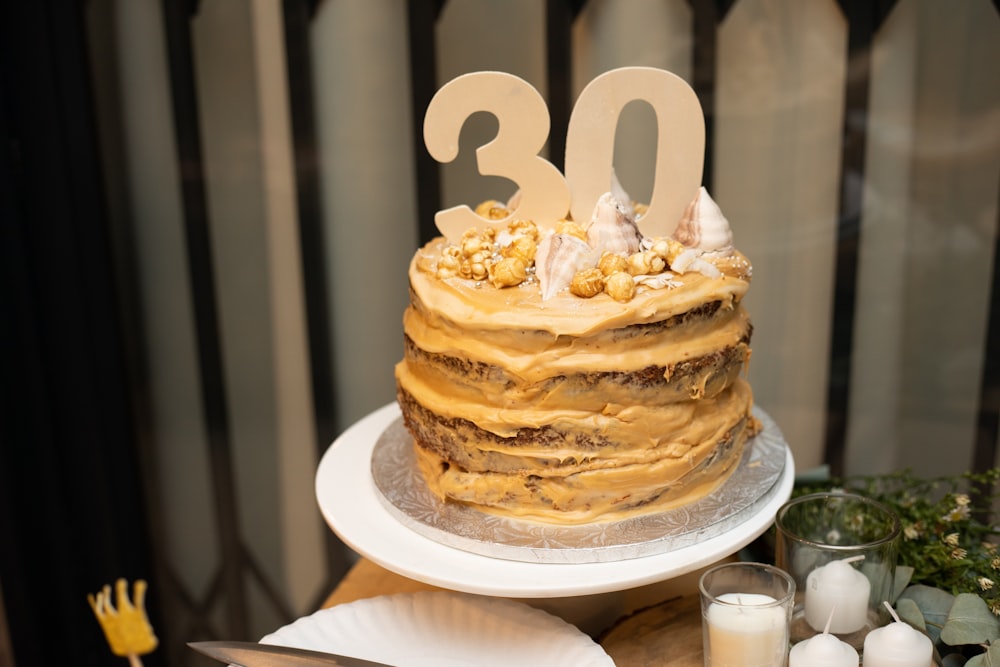 peanut butter cake on plate near unlit candles