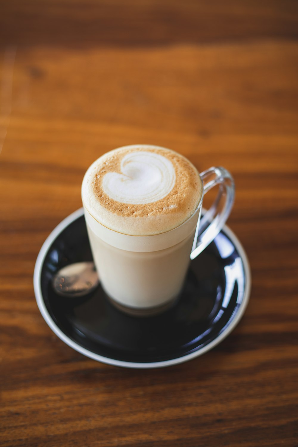 clear glass mug with latte art