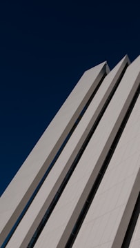 A panoramic view of a modern industrial complex with clean architectural lines under a clear blue sky.