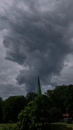 A dramatic depiction of towering storm clouds over Nevis, symbolizing the great hurricane.