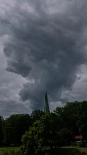 A dramatic depiction of towering storm clouds over Nevis, symbolizing the great hurricane.