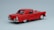 A classic red vintage car model is positioned against a plain light gray background. The car features a sleek, shiny surface with chrome accents on the bumpers and hubcaps. Its design highlights round tail lights and elegant curves typical of mid-20th-century automobiles.