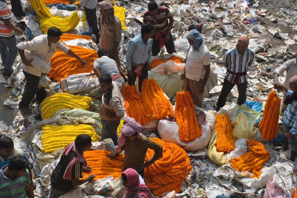 people standing surrounded by textiles