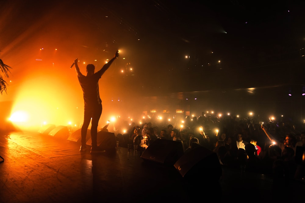 silhouette of person on stage inside dark room