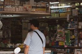 Friendly staff assisting customers in a light blue themed medical supply store.