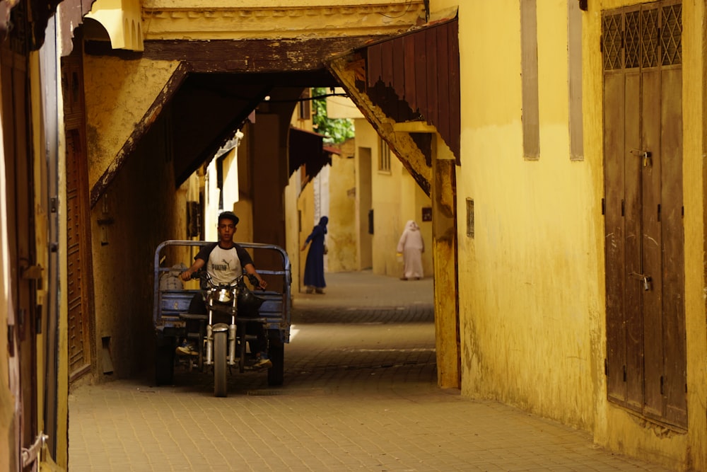 person riding motorcycle besides steel gates