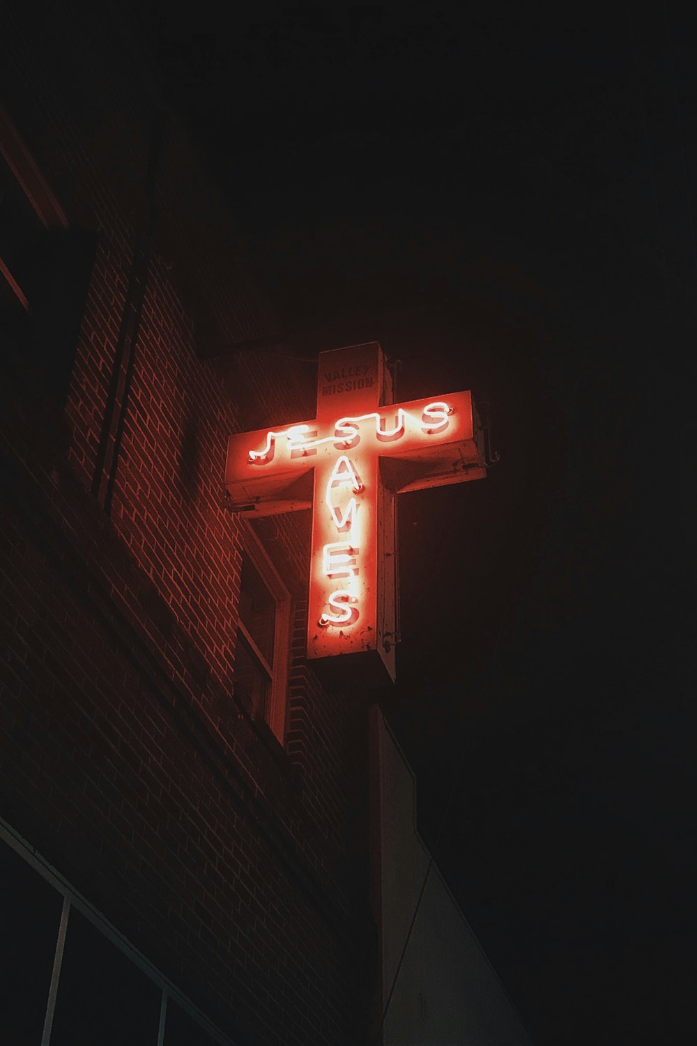 red Jesus Saves neon signage