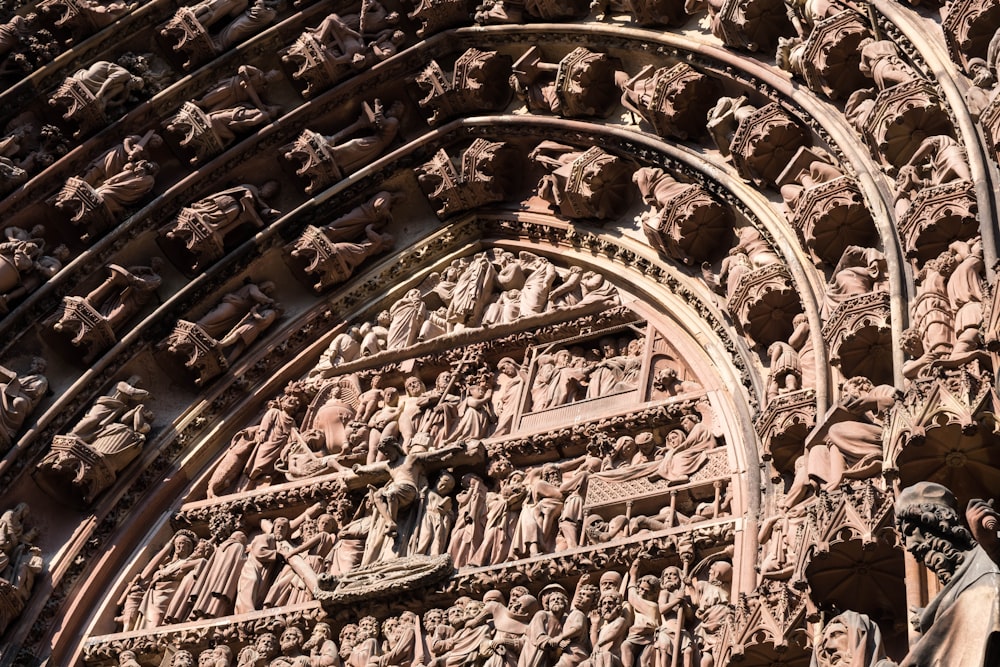 a close up of a building with statues on it