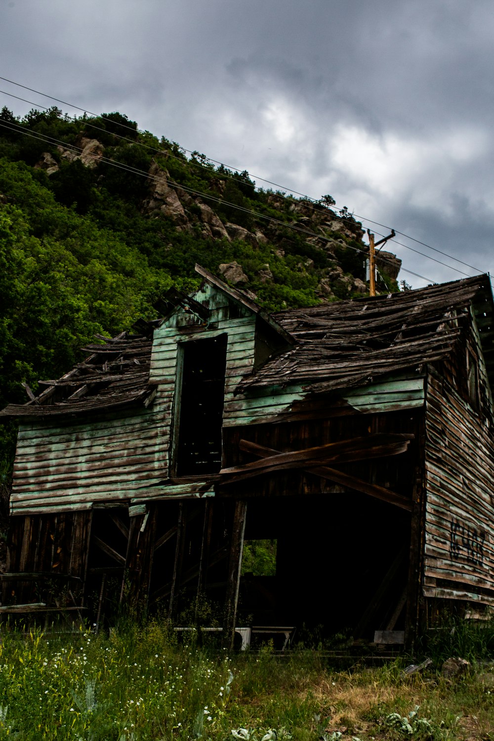 teal and brown wooden cottage ruins