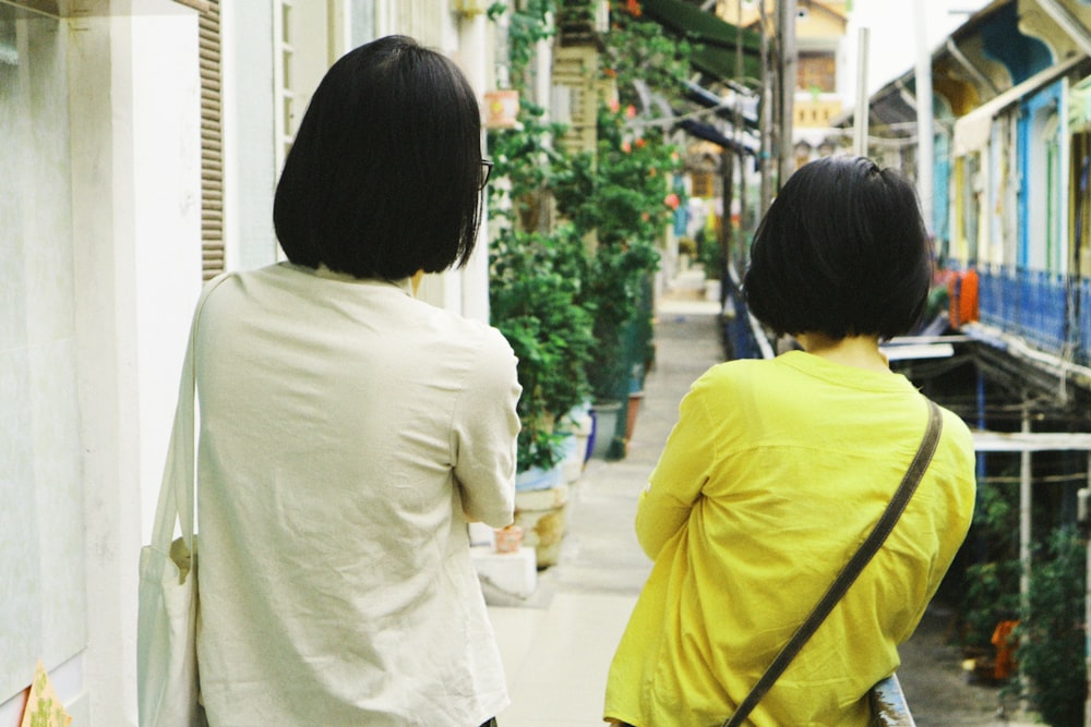 two person standing and facing back
