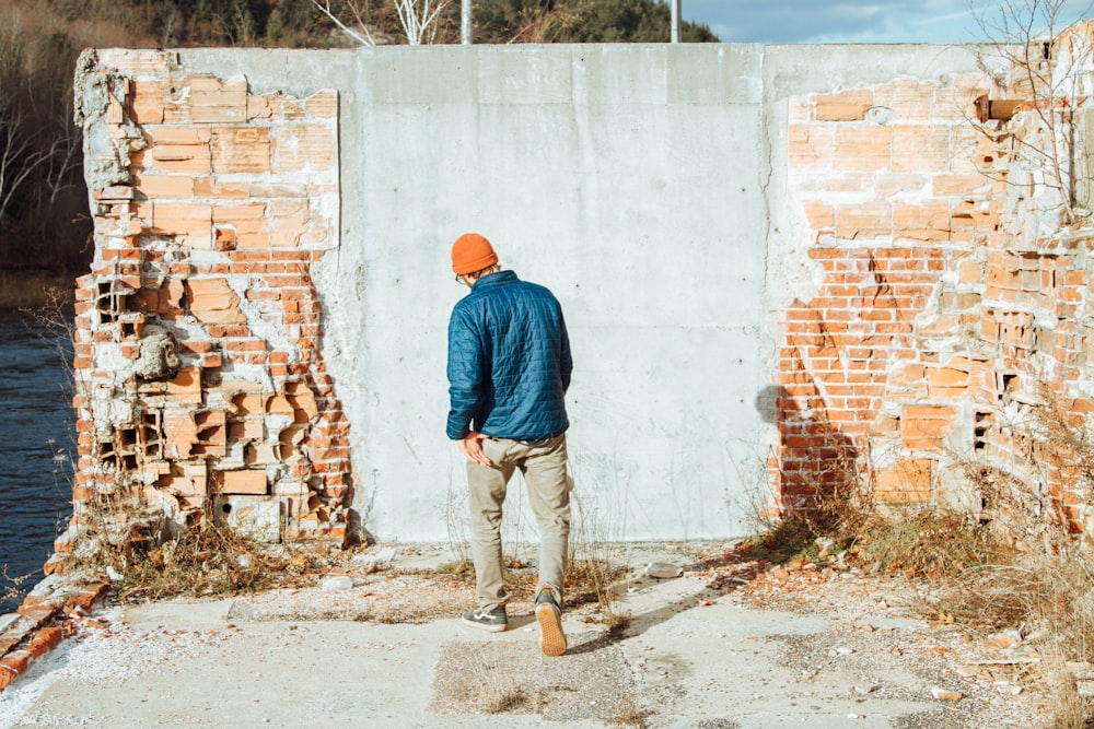man standing in front of concrete wall