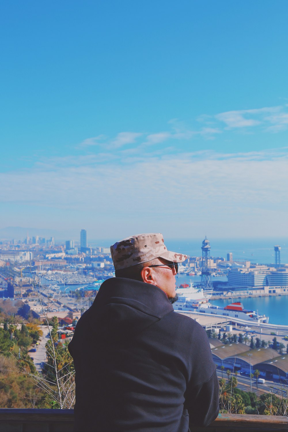 man in black jacket watching cityscape