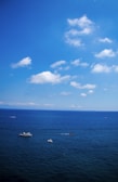 A panoramic view from the boat showing the vast Mediterranean Sea under a bright blue sky.