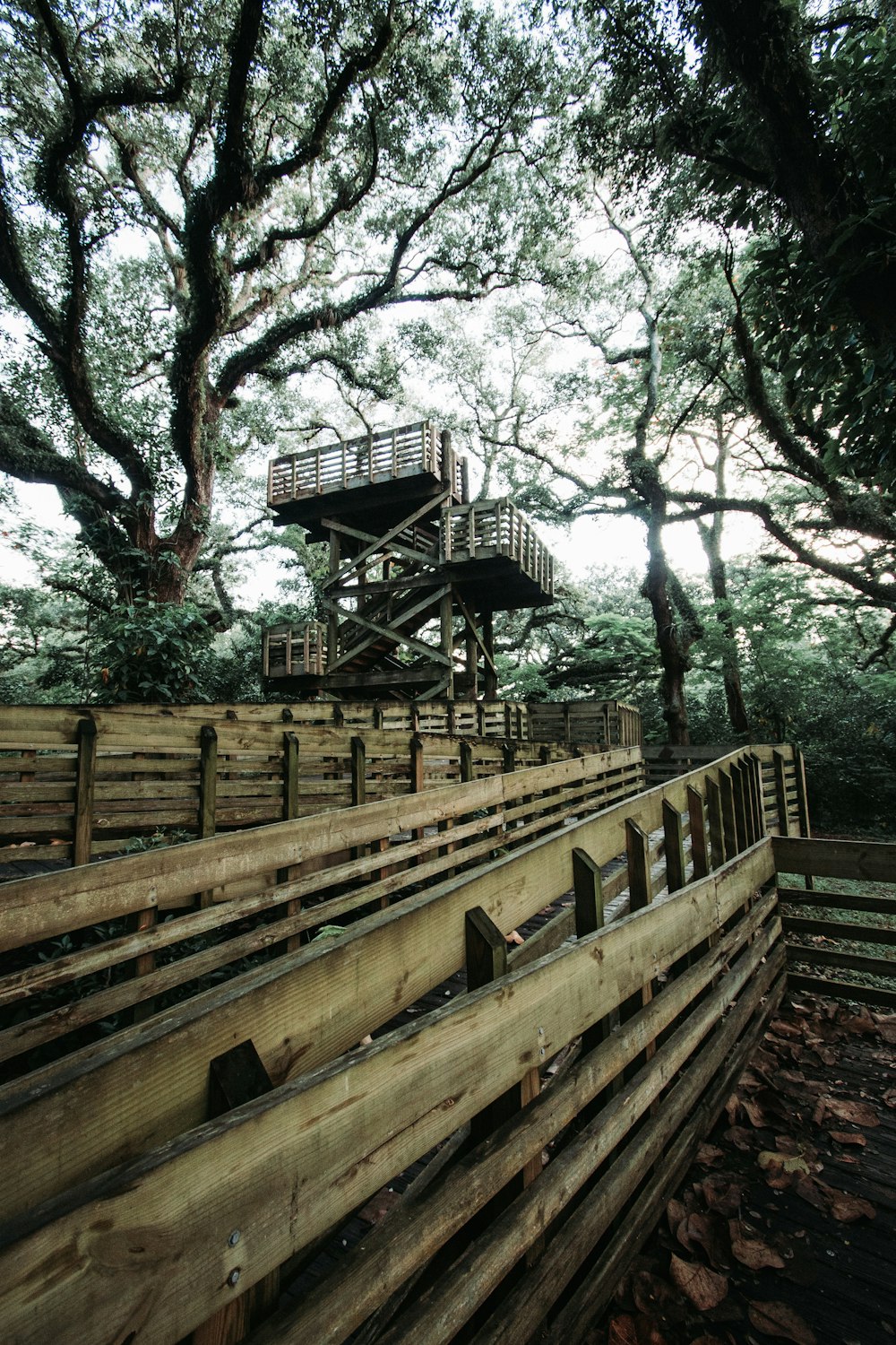 wooden tower near trees and fence