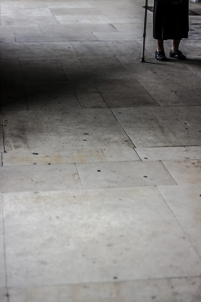 Person walking with a cane, representing gait and mobility support