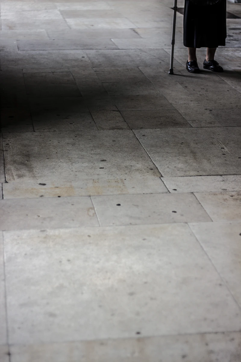 Person walking with a cane, representing gait and mobility support