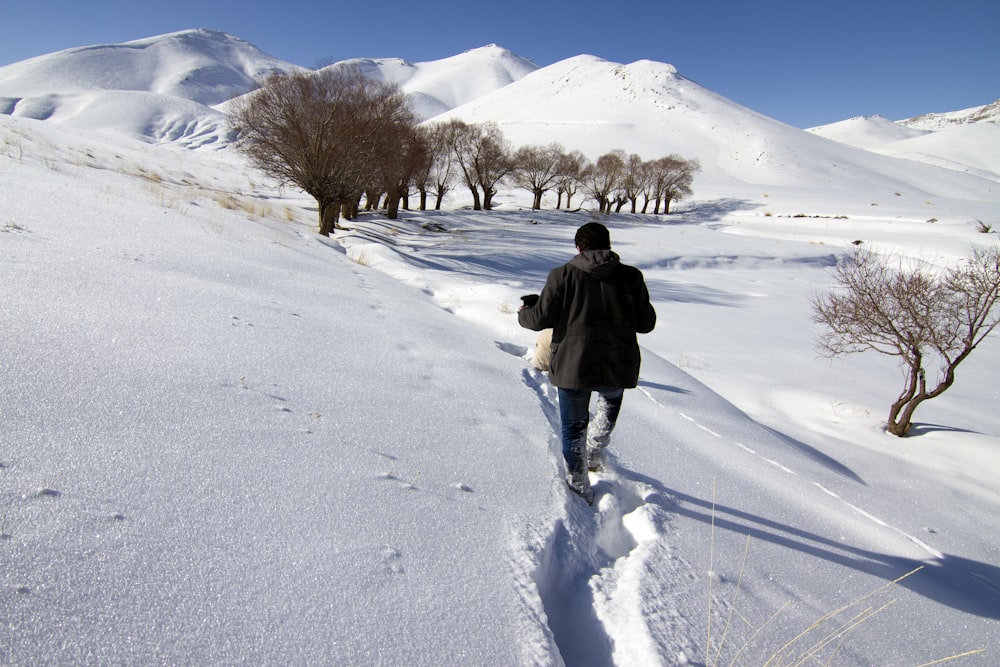 man walking through snow