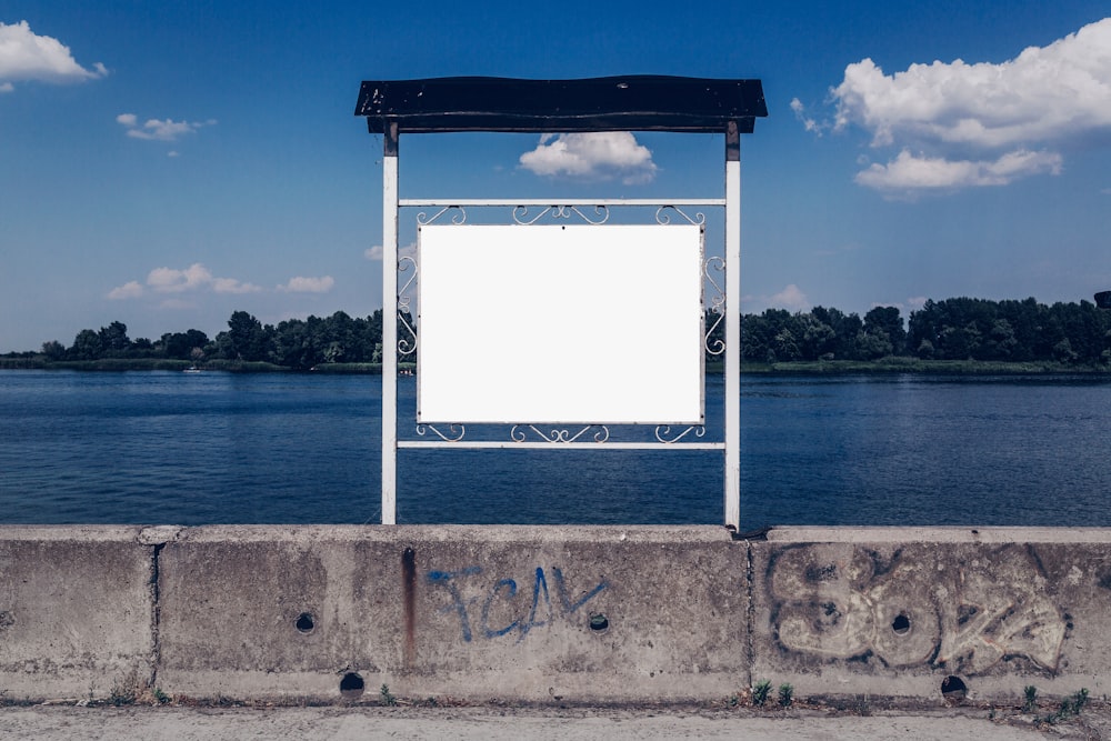 white and black metal frame near body of water