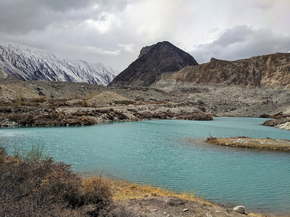 body of water under cloudy sky