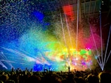 people watching concert with multicolored stage light display