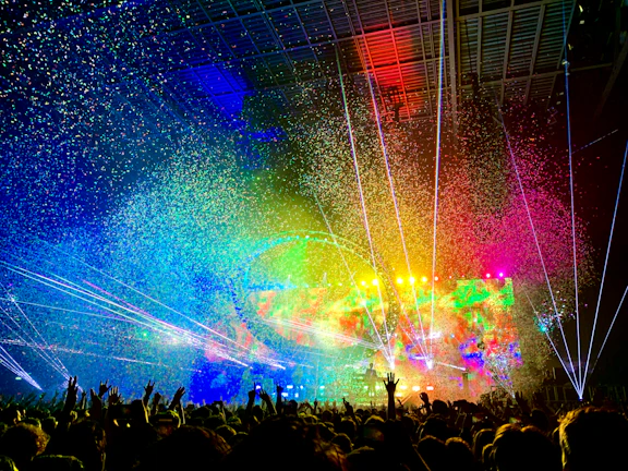 Crackers and bright sparkle effects illuminating a concert crowd in Pakistan.