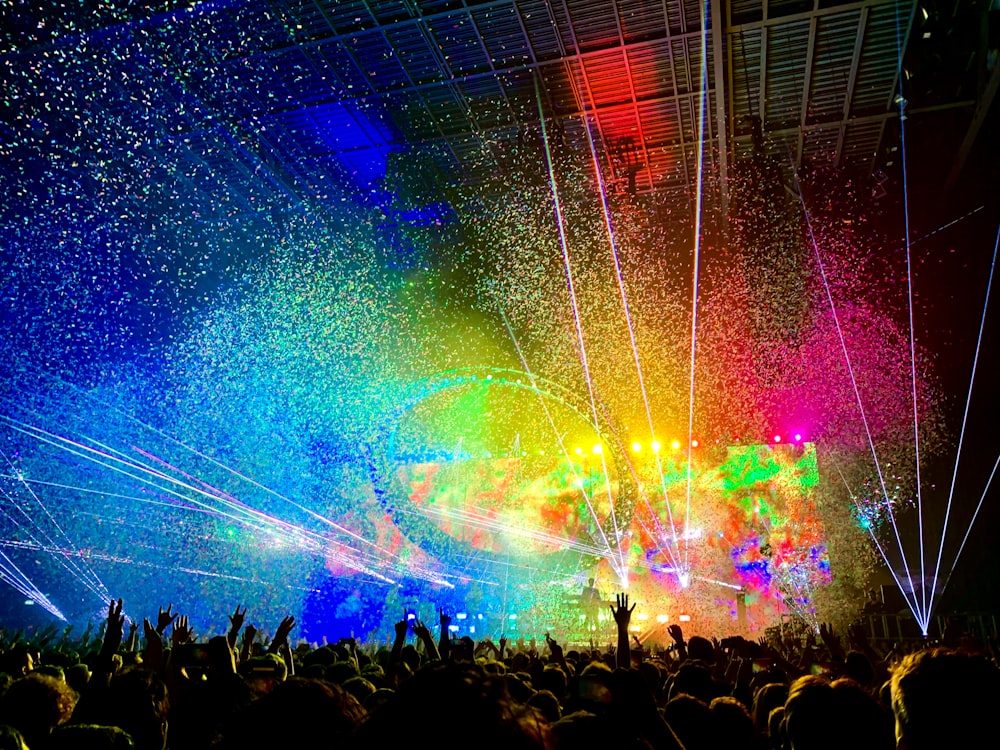 people watching concert with multicolored stage light display
