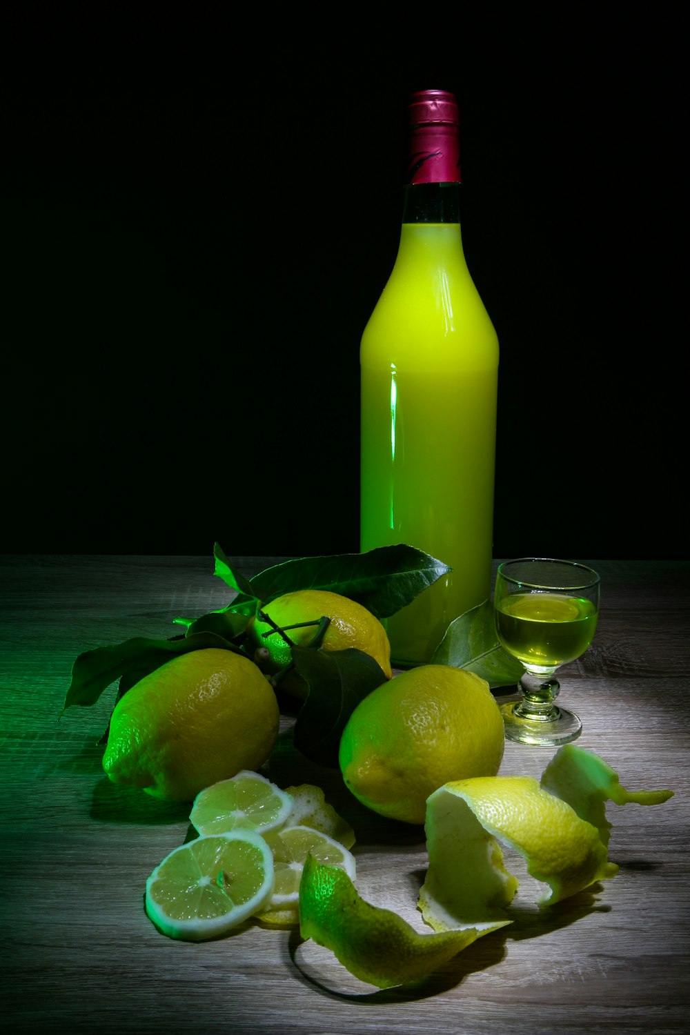 lemon fruits and yellow glass bottle