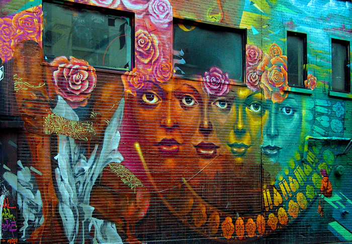 A graffiti painting of a face and flowers