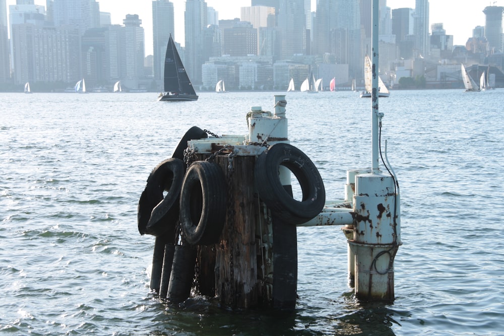 vehicle tires attached to wooden poles at the harbor